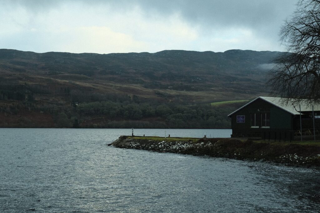 Foreground shot of a Loch Ness cabin, moody Fujifilm aesthetic